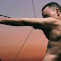 Olly Alexander with bow and arrow