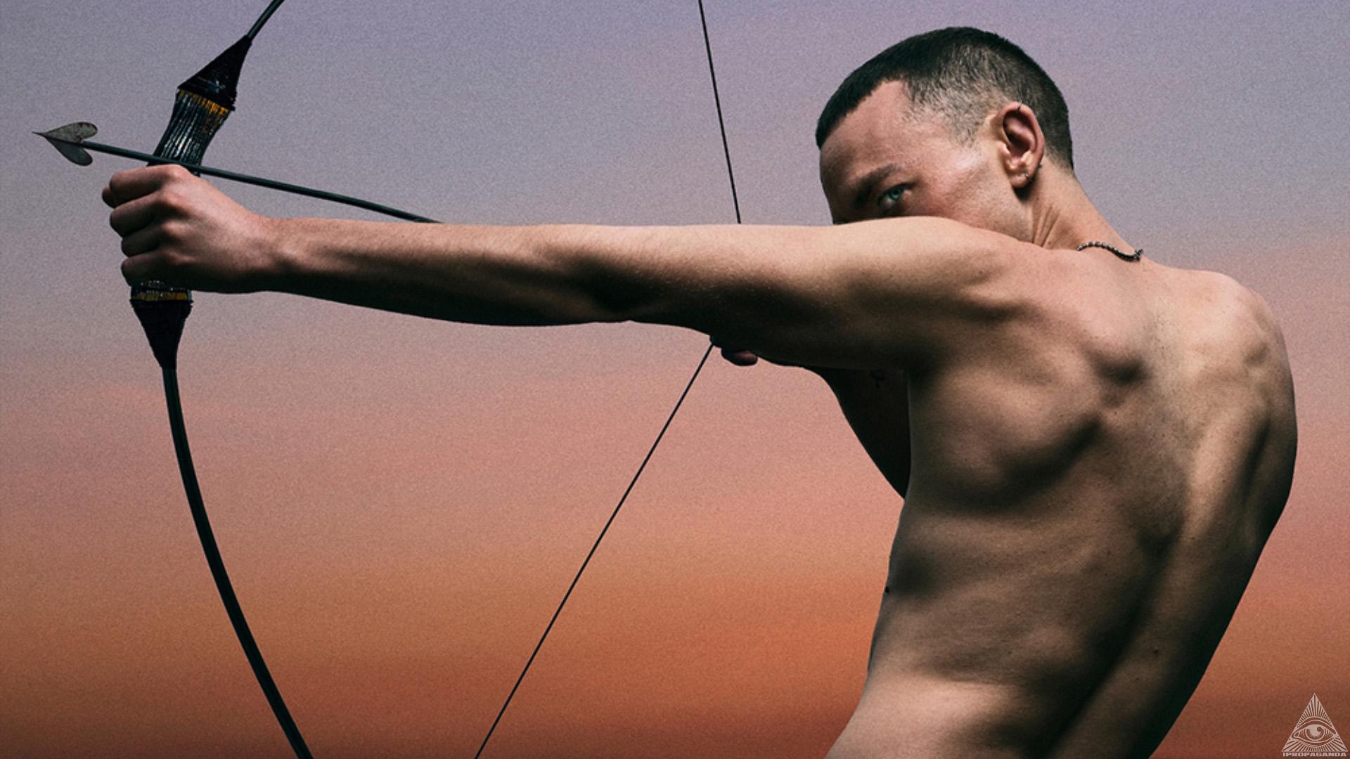 Olly Alexander with bow and arrow
