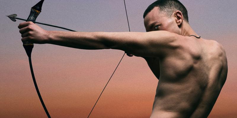 Olly Alexander with bow and arrow