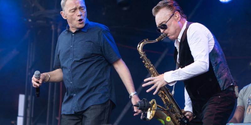 Duncan Campbell (left) and Brian Travers of UB40 perform live onstage during the Rewind Scotland festival at Scone Palace on July 22, 2018 in Perth, Scotland. The saxophonist died Sunday at 62.