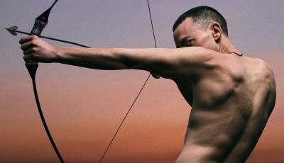 Olly Alexander with bow and arrow